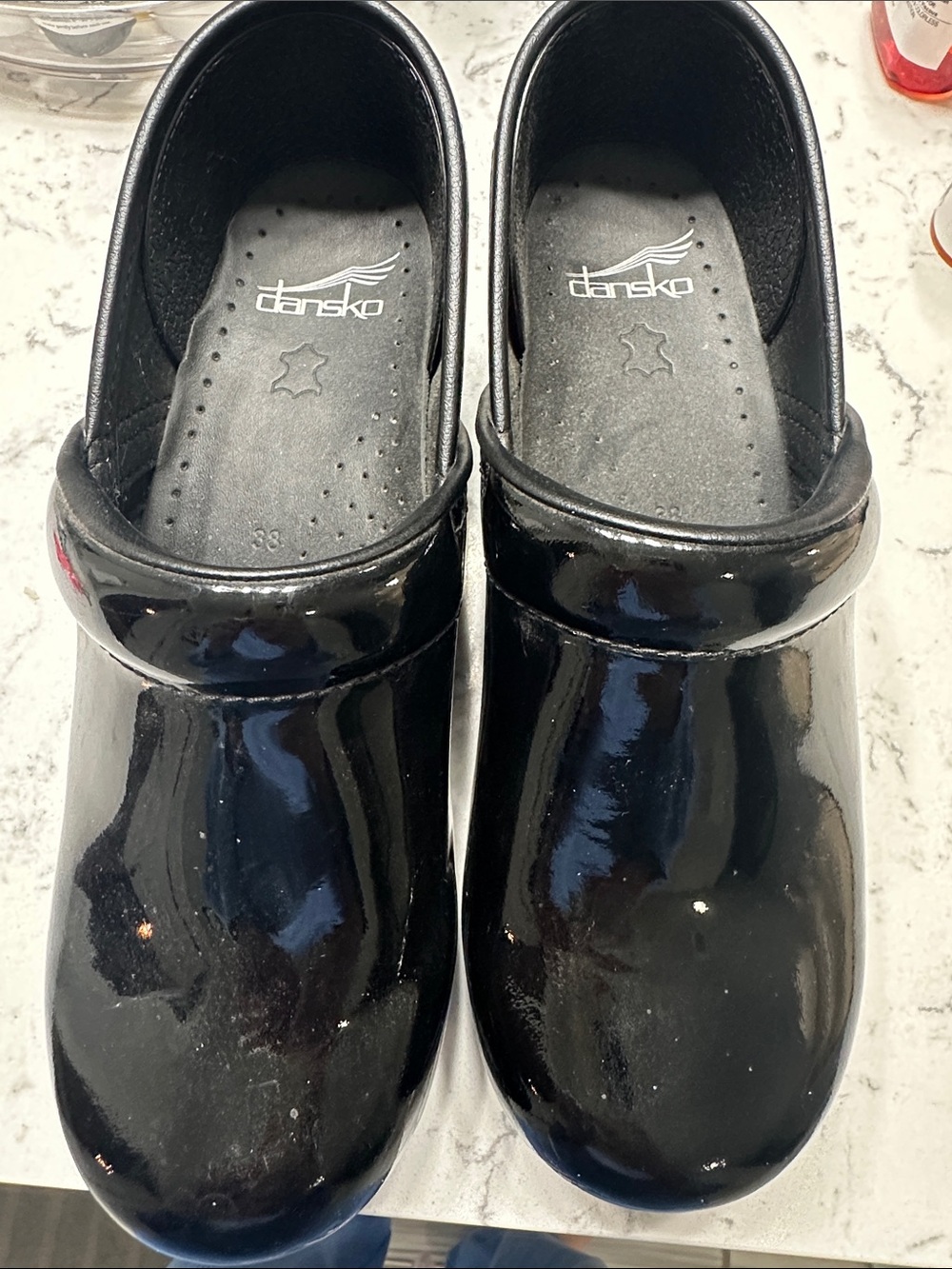 Dansko Black Patent Clogs with Slip-On Strap